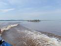 Speeding trough Stanley Pool on the Congo river with a barge on the back ground.